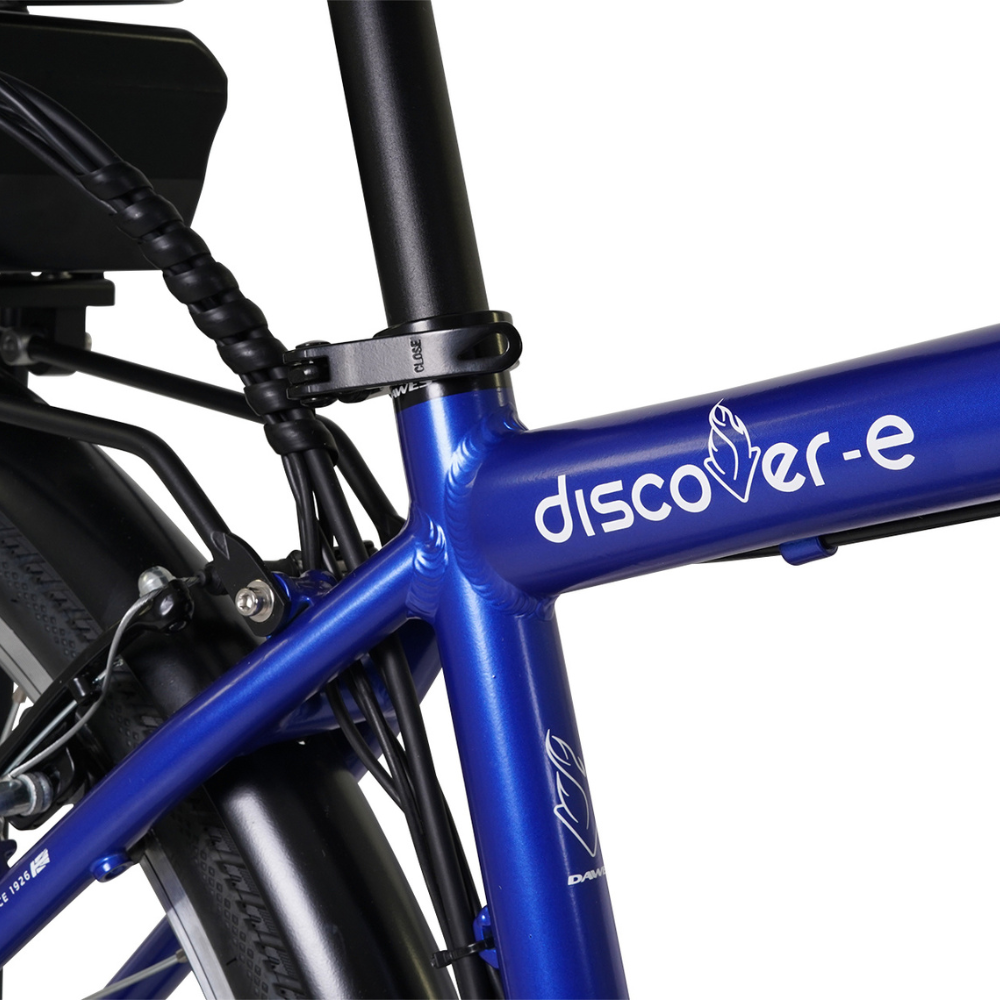 DAWES Discover-E Electric Trekking Bike, 15.5MPH close up of the logo on the crossbar frame in a white studio setting