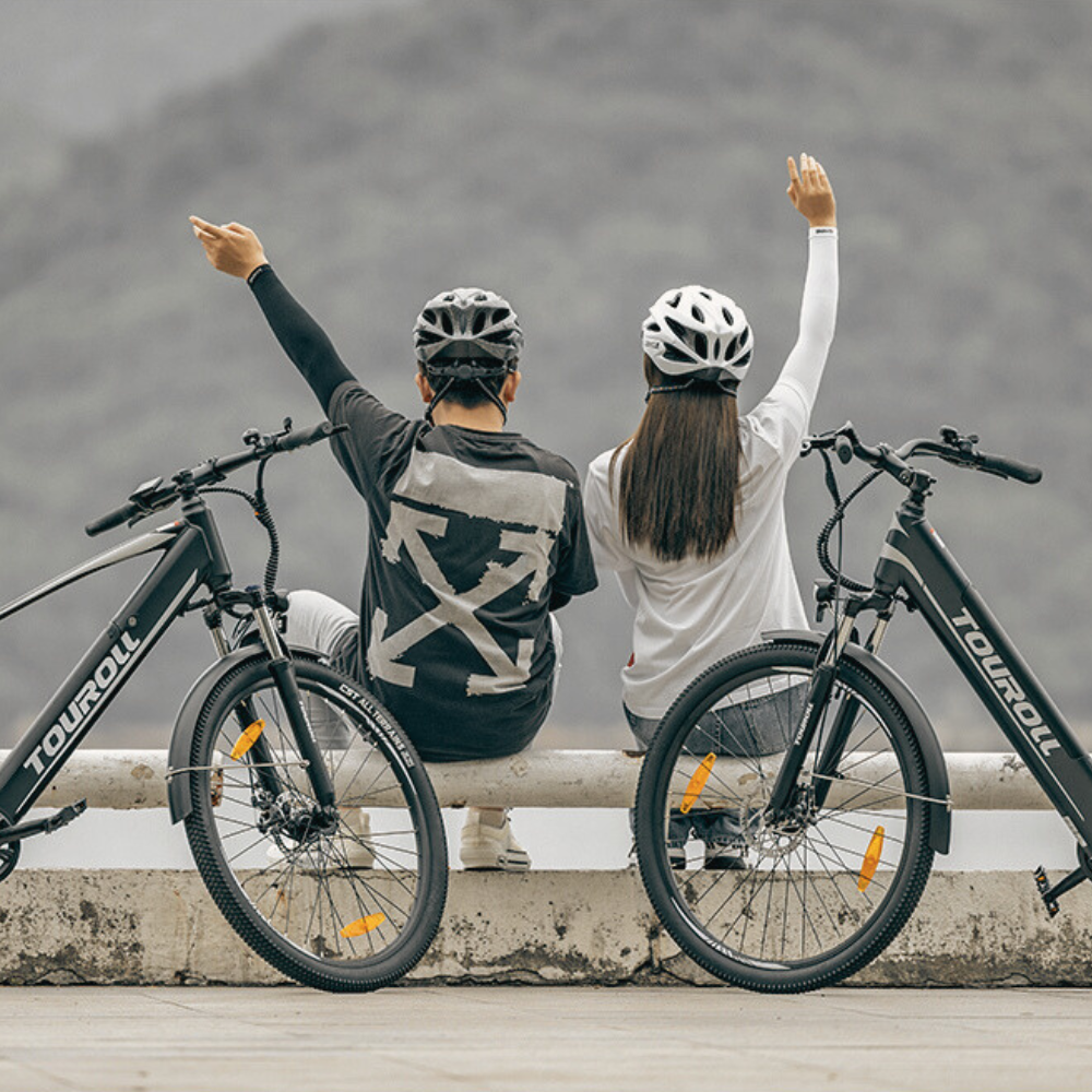 Touroll bikes with two people in an outdoor setting.