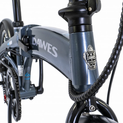 DAWES Arc II Electric Folding Bike, 15.5MPH close up of the Dawes badge on the main bike stem in a white studio setting