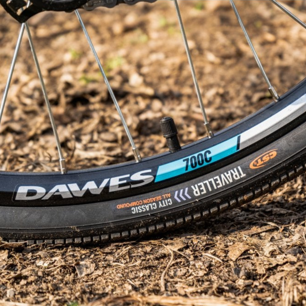 DAWES Mojav-E Electric Trekking Bike - Grey, 15.5MPH close up the tyre markings outside on some bark mulch