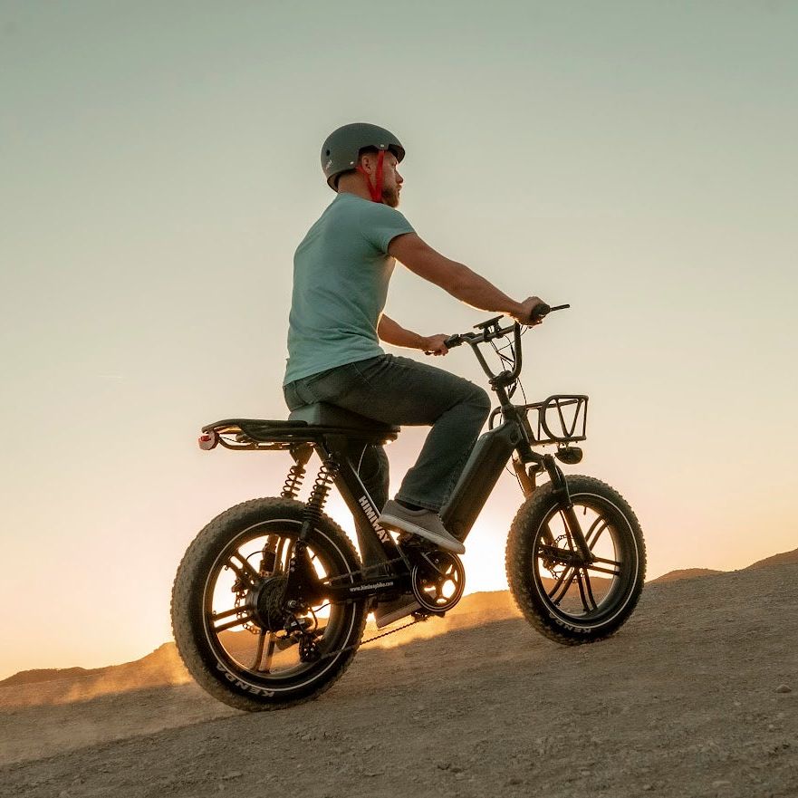 Himiway Escape Pro. Moped-Style Long Range Electric Bike Riding Up A Gravel Hill 