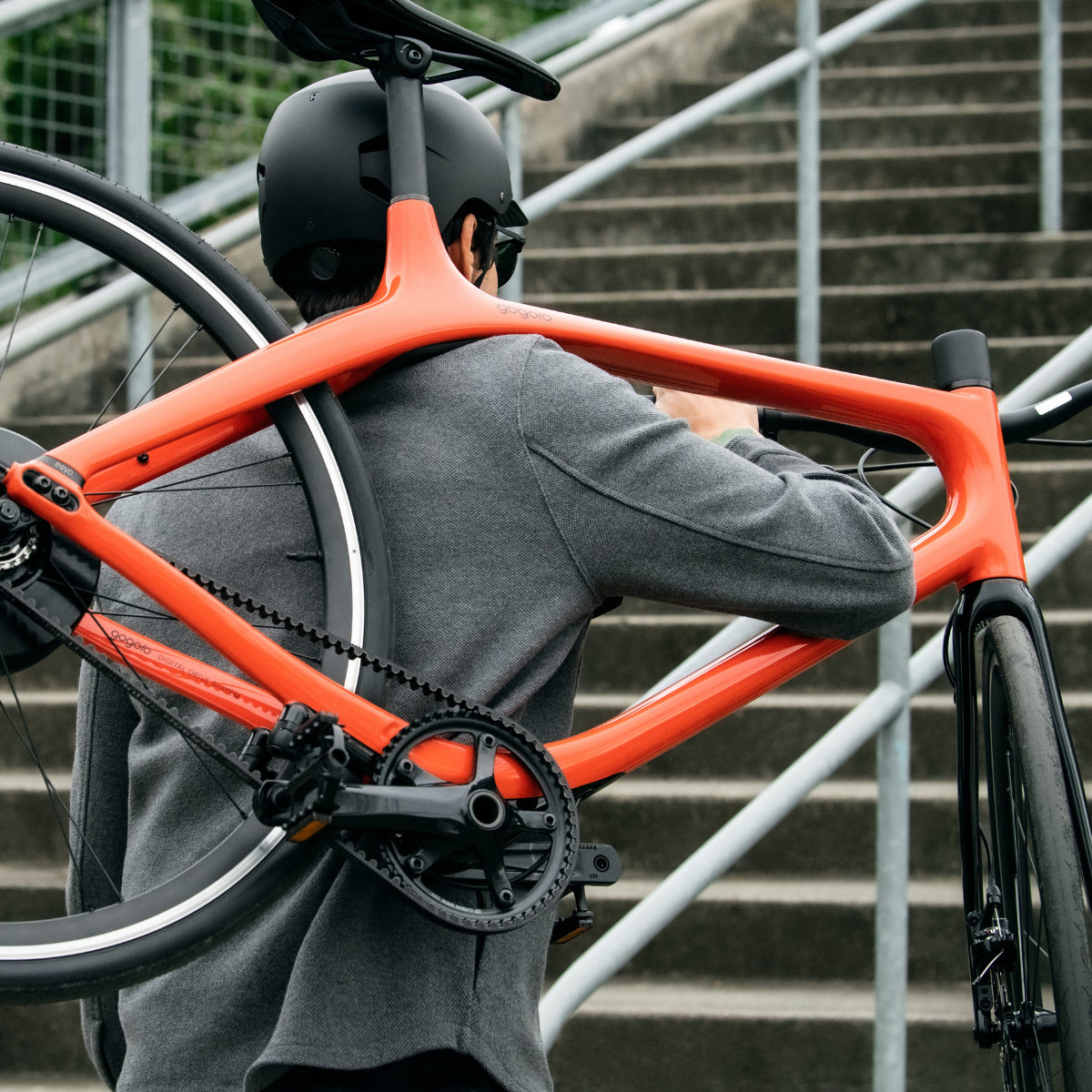 Gogoro Eeyo1 Electric Road Bike Magma Orange Carrying On Shoulders