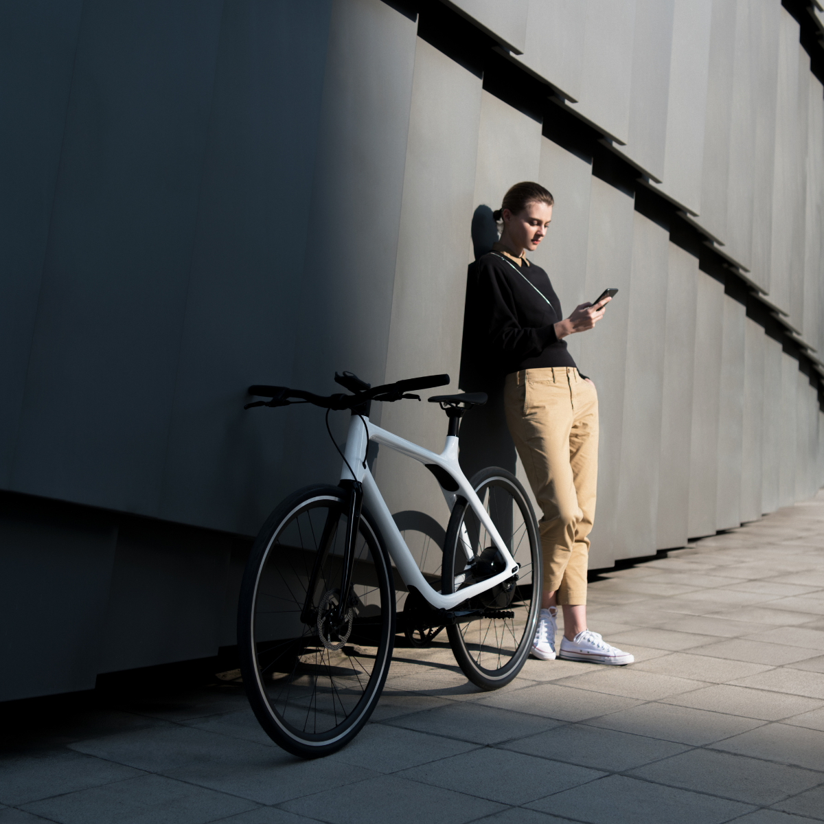 Gogoro Eeyo1 White With Woman Leaning On A Building