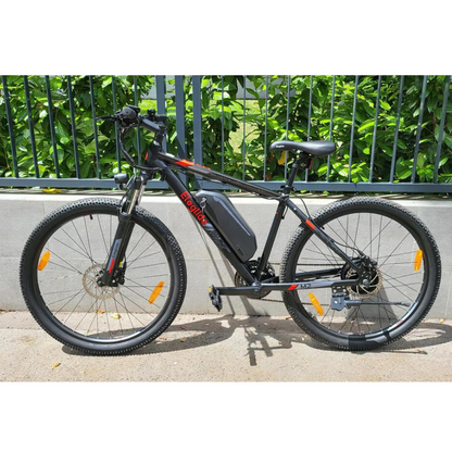 Eleglide M2 29" Electric Mountain Bike, 15.5MPH on its side stand next to a wall and railings in an urban setting