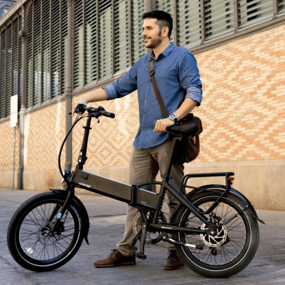 Legend MONZA Folding Electric Bike, 15.5MPH, black in a city setting with the rider 
