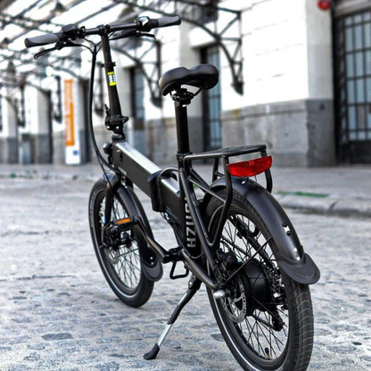 Legend MONZA Folding Electric Bike, 15.5MPH, black in a city setting on a street 