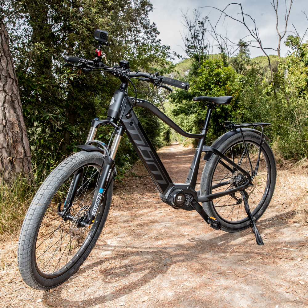 MBM Kairos 27.5" SUB Electric Trekking Bike, Mid Drive, 15.5MPH On The Stand In A Wood