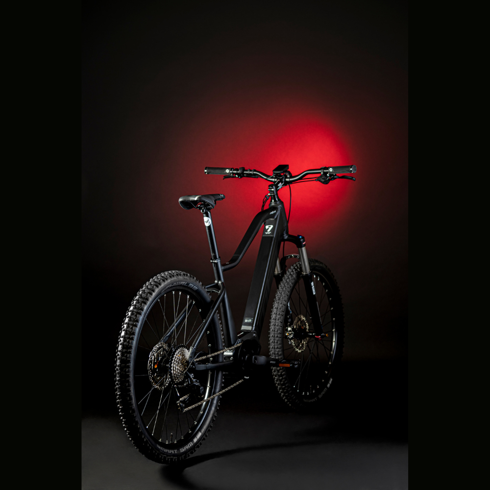 MBM Kairos 29" Electric Mountain Bike, Mid Drive 15.5MPH Facing Right Away Red Highlight Dark Background