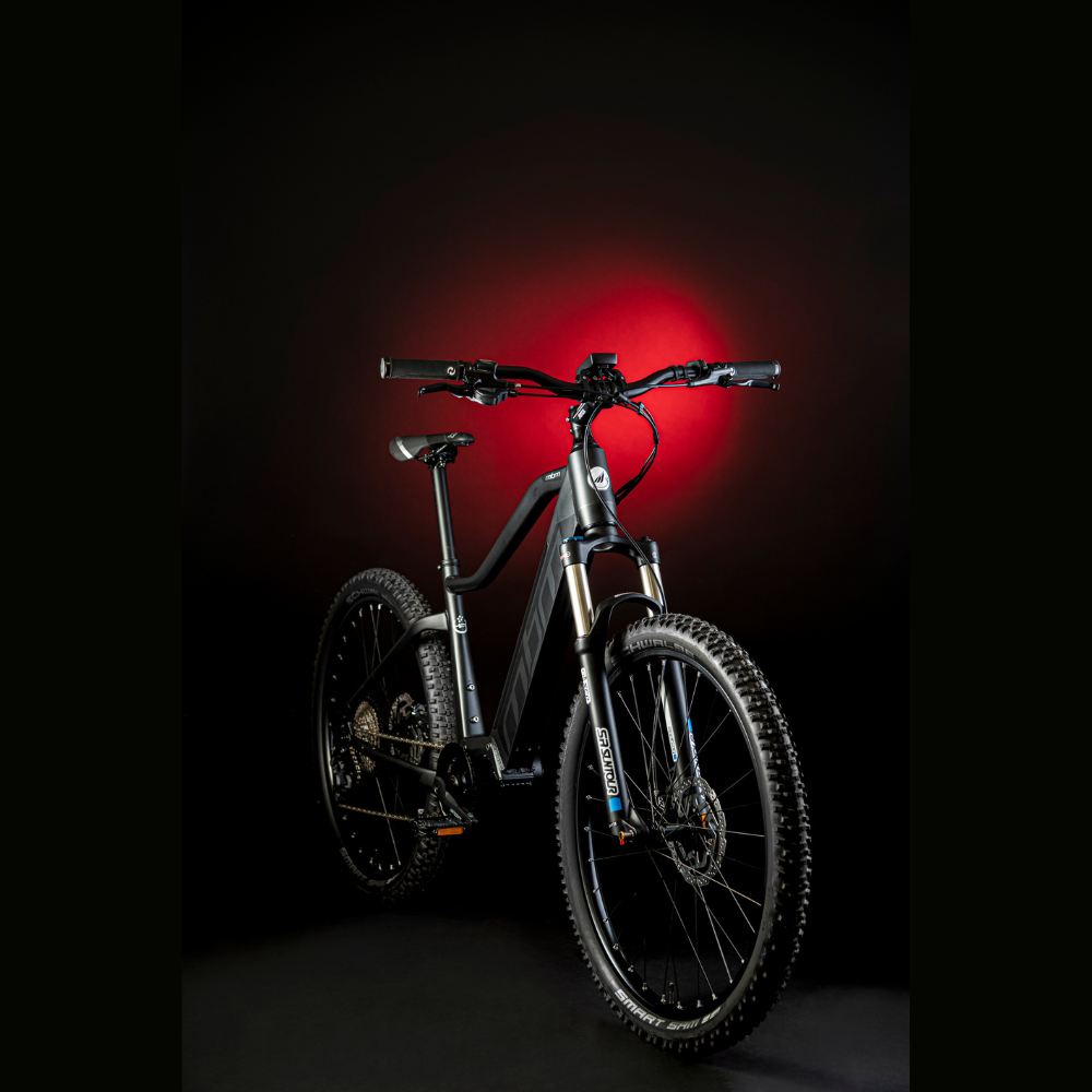 MBM Kairos 29" Electric Mountain Bike, Mid Drive 15.5MPH Facing Oblique Right Red Highlight Dark Background