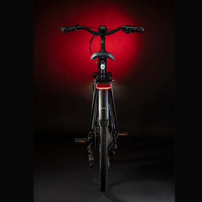 MBM Sinope Step Thru Urban Electric Bike, 15.5MPH View from the rear in a dark studio with red highlighting