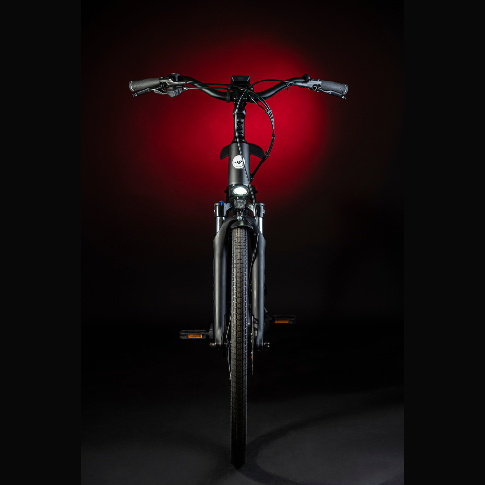 MBM Sinope Step Thru Urban Electric Bike, 15.5MPH View from the front of the bike in a dark studio with red highlighting