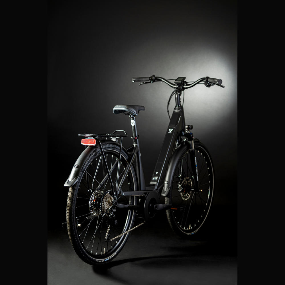 MBM Sinope Step Thru Urban Electric Bike, 15.5MPH Facing oblique right away in a dark studio with white lighting