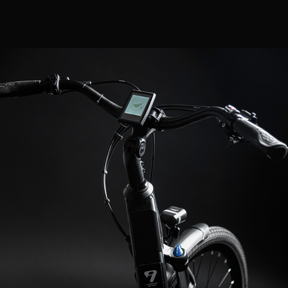 MBM Sinope Step Thru Urban Electric Bike, 15.5MPH Close up of the display screen and handlebars in a dark studio with white highlighting