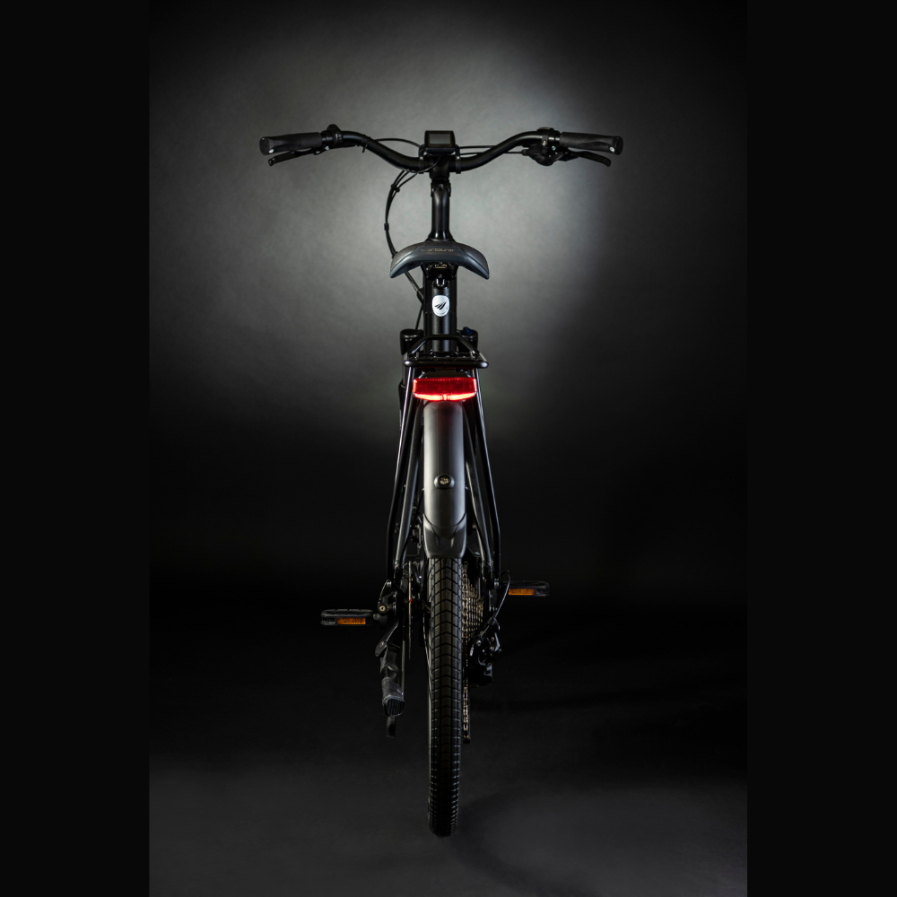 MBM Sinope Step Thru Urban Electric Bike, 15.5MPH From the rear in a dark studio with white high lighting